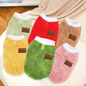 Detail of colorful fleece pet sweaters featuring checkerboard pattern and D-ring traction hooks