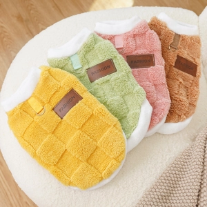 Detail of warm plush pet vest featuring grid texture, leather tag and D-ring traction hook