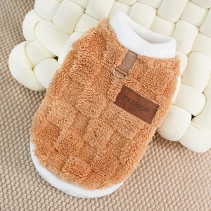 Detail of plush pet vest with metal D-ring and fashion leather patch on brown fabric