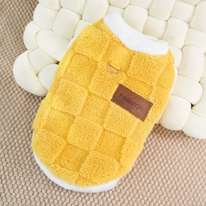 Close-up of yellow fleece pet vest featuring a metal D-ring and a brown leather fashion tag