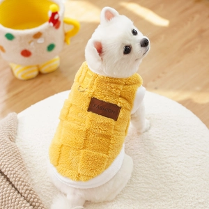 Detail of yellow fleece pet vest with fashion leather tag and D-ring for leash