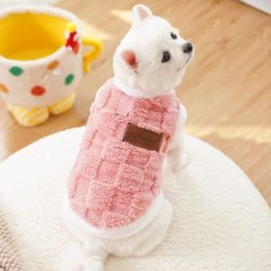 Detail of pink plush pet vest with checkered texture and fashion leather tag