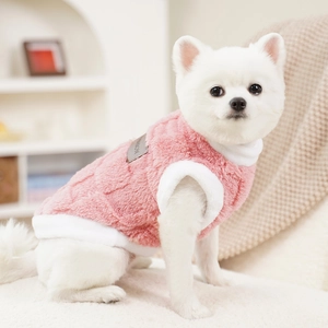 Close-up of pink coral fleece pet vest with soft white plush trim and fashion label