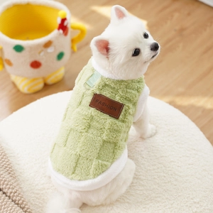 Detail of warm light green plush pet vest with checkered texture and fashion label