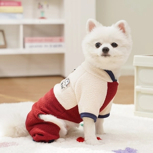 Detail of red and cream fleece dog jumpsuit with 'BEAR' patch and soft elastic cuffs