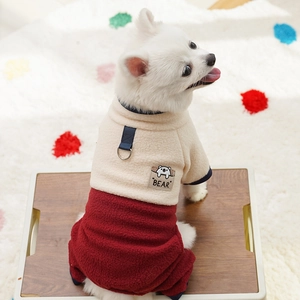 Detail of pet fleece jumpsuit with D-ring and bear patch on warm cream and burgundy fabric