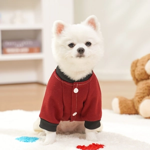 Close-up of red and black pet jacket with premium stitching and button detail