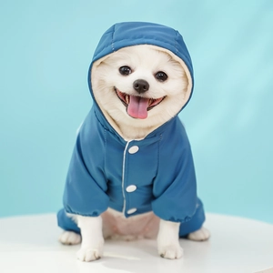 Detail shot of navy blue hooded waterproof dog jacket with white button closure and elastic cuffs