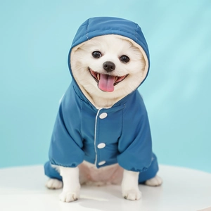 Close-up of waterproof pet jacket featuring white snap buttons and soft hood detail
