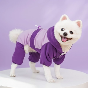 Detail of a purple waterproof pet jumpsuit with adjustable hood and elastic cuffs