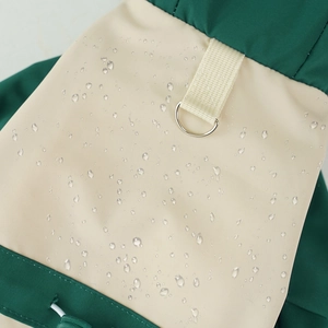 Close-up of waterproof fabric with water droplets and metal D-ring on pet ski jacket