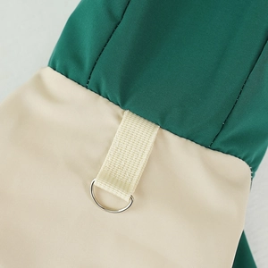 Close-up of waterproof fabric seams and metal D-ring on the pet winter outdoor jacket