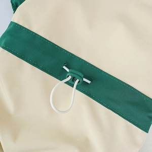 Close-up of waterproof fabric and adjustable drawstring with cord lock on pet jacket
