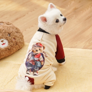 Detail of pet jumpsuit with bear print and D-ring for leash attachment on warm beige fabric