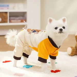 Detail of yellow and white four-legged dog jumpsuit with cartoon bear print for pets