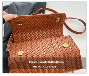 Close-up of brown woven flap bag featuring secure double magnetic snap closures
