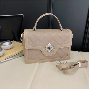 Quilted beige faux leather handbag with silver flower clasp and top handle for women