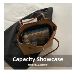 Flat lay showing large capacity interior of brown leather tote bag with daily essentials