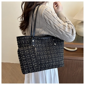 Detail of tweed tote bag with gold thread weaving and matching mini pouch on shoulder strap