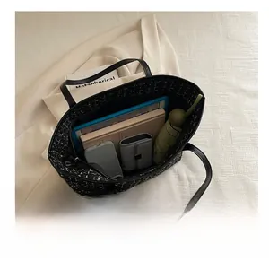 Top view of black tweed tote bag showing spacious interior with tablet and daily essentials