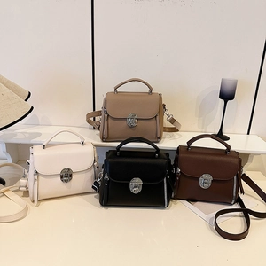 Chic pebbled faux leather crossbody bag with silver twist lock and thick top handle