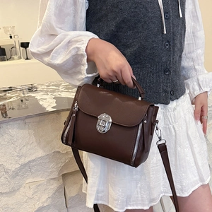 Dark brown pebbled leather satchel with silver buckle and detachable shoulder strap