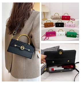 Detail view of colorful crossbody bags showing M buckle, top handle and inner space