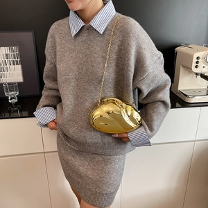 Sleek gold metallic evening bag with mirror finish and long chain strap for women
