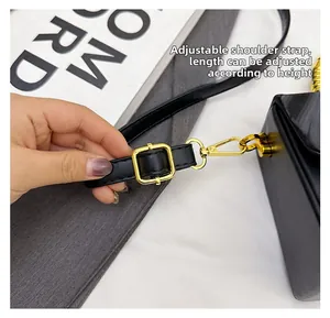 Detail of adjustable black leather strap with polished gold buckle and lobster clasp