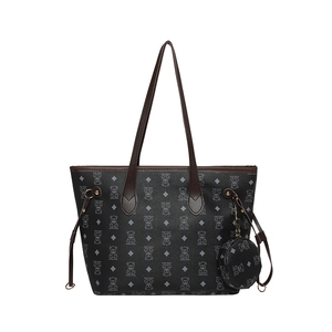 Large gray tote bag with bear print, matching small pouch, and brown leather straps