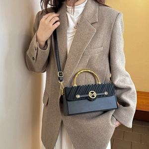 Chic black crossbody box bag with wavy texture and golden metal handle for women