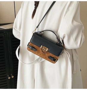 Detail of contrast patchwork handbag with quilted suede texture and gold buckle