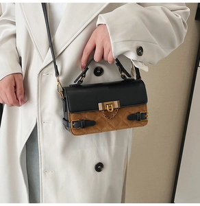 Detail of vintage crossbody bag with black and brown quilted leather and gold buckle