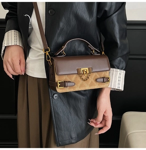 Close-up of diamond lattice stitching and gold metal lock on luxury crossbody bag