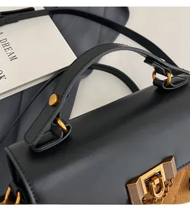 Detail of premium vintage tote with black leather flap and brown quilted suede texture