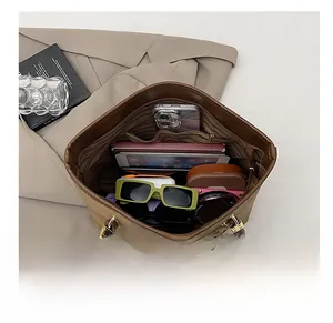 Vue du dessus de l'intérieur spacieux d'un cabas marron contenant tablette et objets