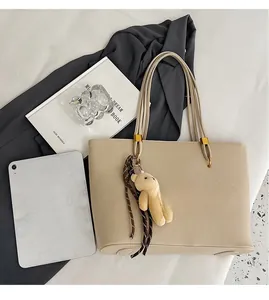 Spacious beige tote bag detail showing large capacity with tablet and daily essentials