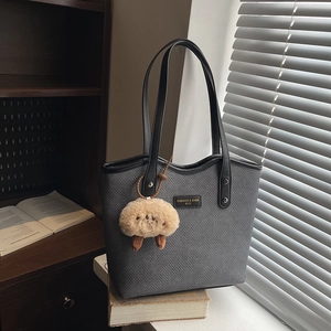 Grey woven texture tote bag with black leather handles and cute plush sheep pendant