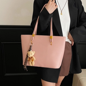 Pink lychee texture tote bag with long handles and a cute bear charm for daily commute