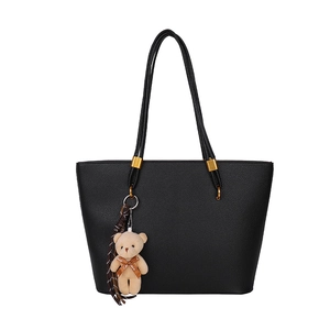 Classic black litchi grain tote bag with thin straps and cute beige teddy bear charm