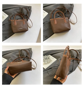 Macro detail of brown litchi pattern leather tote with golden fashion metal plaque