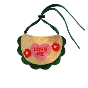 Beige knitted pet bandana with green wavy trim and pink love me embroidery