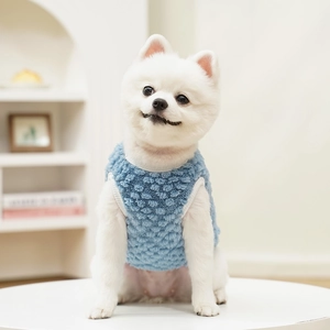 Detail of light blue fleece pet vest showing fluffy texture and premium white piping finish