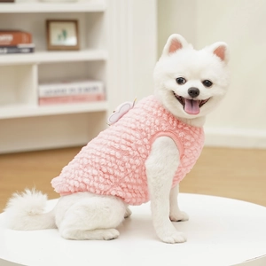 Detail view of pink fleece pet vest with soft texture and cute wing decor on a Pomeranian