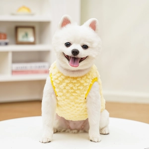 Close-up of yellow fleece dog vest with soft lamb velvet texture for puppies
