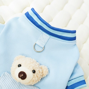 Detail of blue pet varsity sweater with metal D-ring leash attachment and 3D plush bear