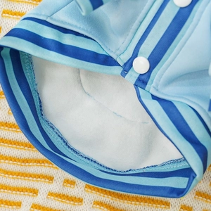 Close-up of warm fleece lining and high-quality stitching on a blue dog baseball jacket