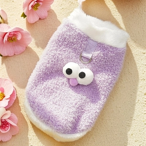 Detail of purple plush pet vest with cartoon eyes and metal D-ring for leash attachment