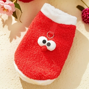 Close-up of thick red pet fleece vest featuring cartoon eyes and a metal leash D-ring