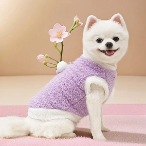Close-up of soft purple plush pet vest with white fleece trim and fluffy warm texture